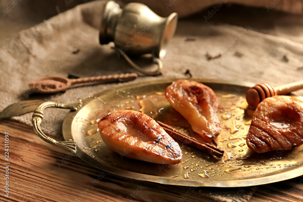 Tasty grilled and baked pears with honey on tray