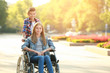 © Pixel-Shot - Teenage girl in wheelchair and her brother outdoors