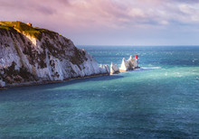 A Break In The Clouds Illuminates The Iconic Chalk Stone Pinnacles Of The Needles And The 19th Century Lighthouse On The Coastline Isle Of Wight An Island Off The South Coast Of England