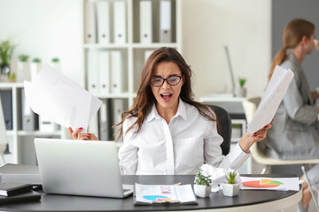 Poster - Stressed businesswoman at table in office