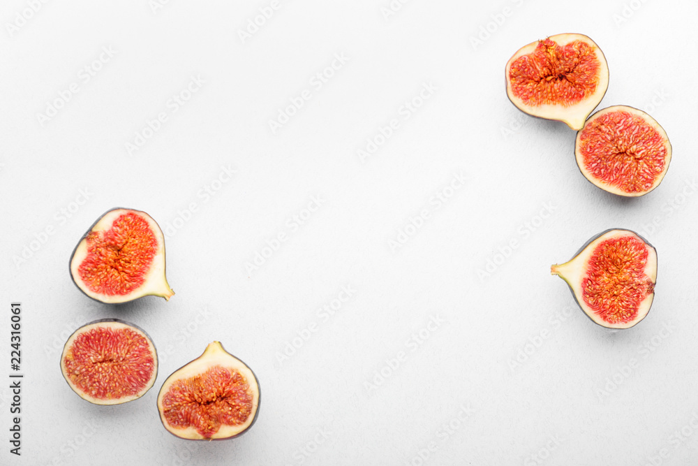 Ripe cut figs on white background