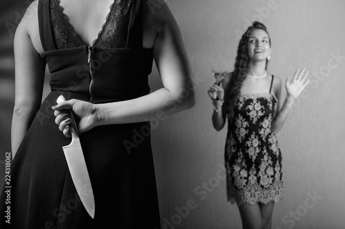 Fotografie, Obraz Insidious woman with knife in her hand and her rival.