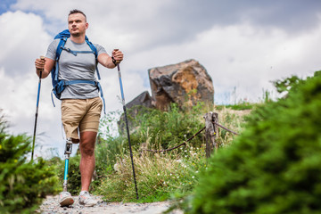 Wall Mural - Low angle of a determined man with prosthesis standing outdoors