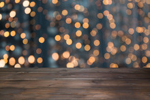 Blurred Gold Garland And Wooden Tabletop As Foreground. Image For Display Or Montage Your Christmas Products.