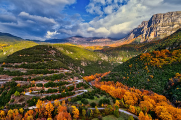 Aerial view of the the Vikos Gorge in the autumn and provincial road with many zigzag in the Epirus Zagorohoria, Greece. National park