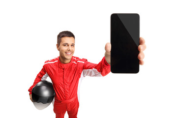 Canvas Print - Man in a racer's suit holding a helmet and a mobile phone