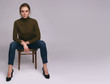 © spaxiax - pretty casual woman is sitting on a chair