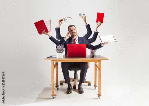 businessman with many hands in elegant suit working and holding office tools Slika na platnu