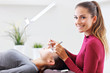 © Kalim - Adult woman having eyelash extension in professional beauty salon