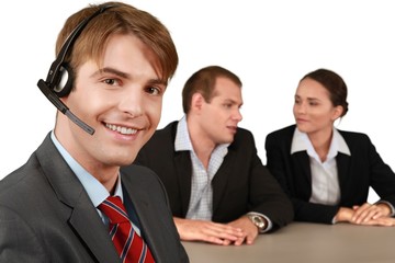 Wall Mural - Smiling Businessman with Headset and Talking Collaborators in