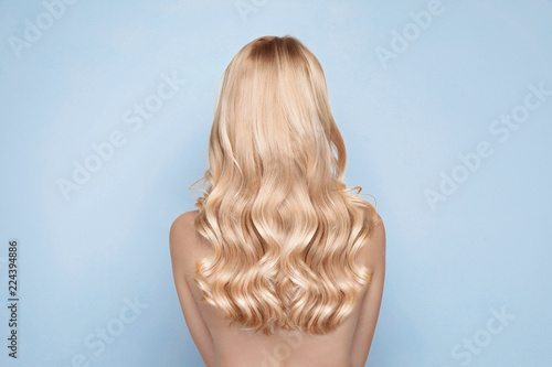 Beautiful Woman With Healthy Long Blonde Hair On Light Background