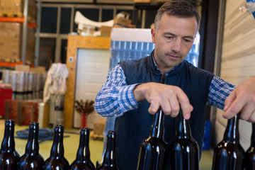 handsome packer on the packaging line at the manufacture