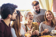 © Mediteraneo - Young friends sharing pizza in a indoor cafe