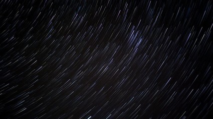 Wall Mural - Night Sky Star Trail Time Lapse Background.  Star trails in night sky