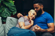 © Gerald Carter/Creative Flame - Young couple embracing each other while sitting on sofa
