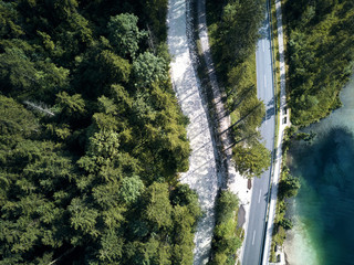Canvas Print - Aerial view of the road near the lake and the forest from above