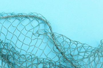 Fishing net with space for your text. Blue background for a fishery theme.