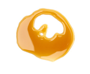 Twirl of Maple Syrup Spilled on a White Background