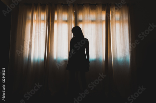 silhouette of woman in window