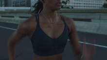 Fit Mixed Race Woman Running On Urban City Road At Sunrise Training Intense Cardio Endurance Workout Female Runner Athlete Wearing Earphones