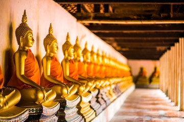 Wall Mural - The Golden Buddha is lined up at Wat Phutthaisawan, Phra Nakhon Si Ayutthaya, the worship of Buddhism in Thailand, the great archaeological site of Thailand,Is a Buddhist mind sticker.