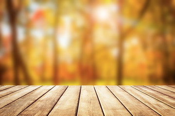 Wooden table top on blur autumn background