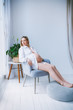 © photoaliona - Pregnant mothercare lifestyle concept, blond Bob hairstyle woman health care. white light interior
