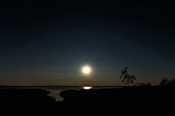 Wall Mural - Night moon sky, full moon, Moon over the lake. Night landscape. Reflection of the rays from the moon in the water.