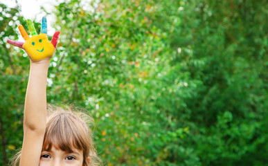 children hands in colors. Summer photo. Selective focus.