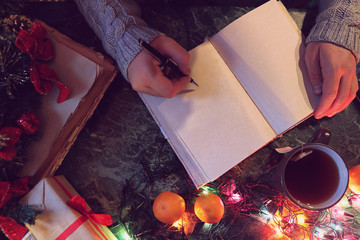 Wall Mural - man with a blank book in his hands for the New Year's table with