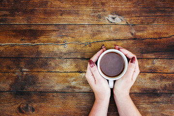 Wall Mural - A cup of tea in the hands. Selective focus.