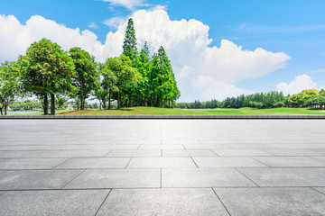 Empty city square floor and green woods scenery