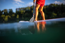 Young Man On A Paddle Board. Getting A Great Exercise On A Lovely River In Warm Evening Sunlight - Paddle Underwater Image