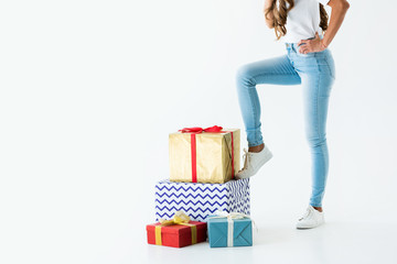 cropped view of woman standing near gift boxes, isolated on white