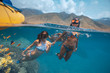 Three girls snorkeling and having fun in blue water