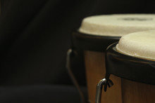 Pair Of Bongos From The Right Side Against A Dark Background And A Dimmer Exposure