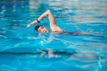 Wall Mural - woman swimming in the swimming pool