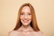 Beauty portrait of a smiling topless redhead girl