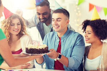 corporate party and people concept - happy team with cake and non-alcoholic drinks celebrating colleague 21st birthday at office party