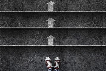 business. success or progres. man legs in sneakers standing next to stairs with arrow