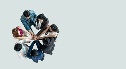 Top view of people in team stack hands together as unity and teamwork in office. young Asian team and group togetherness collaboration