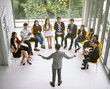 © saksit - Businessman speaker giving a talk at business meeting. Audience in conference room.