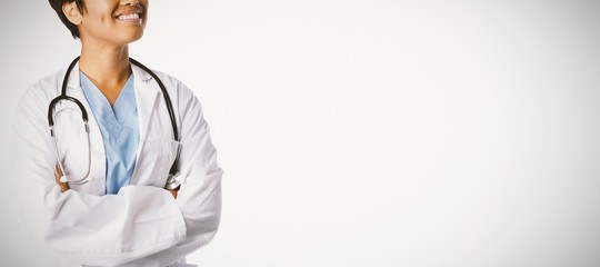 Smiling hopeful female doctor with crossed arms