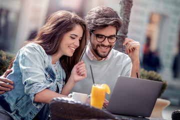 Wall Mural - Young couple in love sitting in cafe