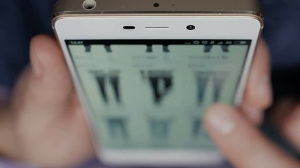 A man looks at the goods in the online clothing store. People using Smartphone, online shopping. Close-up. 4K UHD.