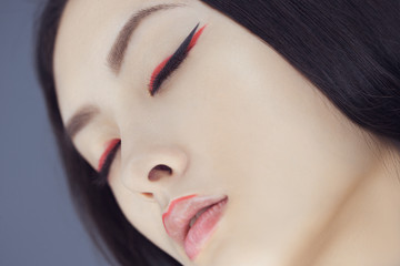 Wall Mural - Asian beauty woman skin care close-up. Beautiful young girl with perfect skin face looking with closed eyes. Isolated on gray background. Tender sensual mixed race Asian Caucasian female in studio