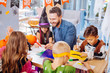 © zinkevych - Painting bats. Smiling handsome bearded father helping his children painting bats and spiders for Halloween