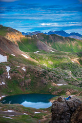 Wall Mural - Tourist rests on its backpack view from California Pass towards lake Como and Poughkeepsie Gulch