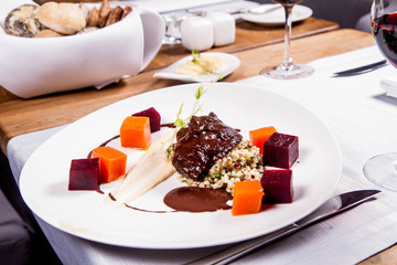 Sticker - Beef cheeks with vegetables, roasted parsley root mousse , pearl barley, dark chocolate and demi glace sauce