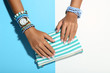 © 5second - Female hands with bracelets and handbag on colorful background